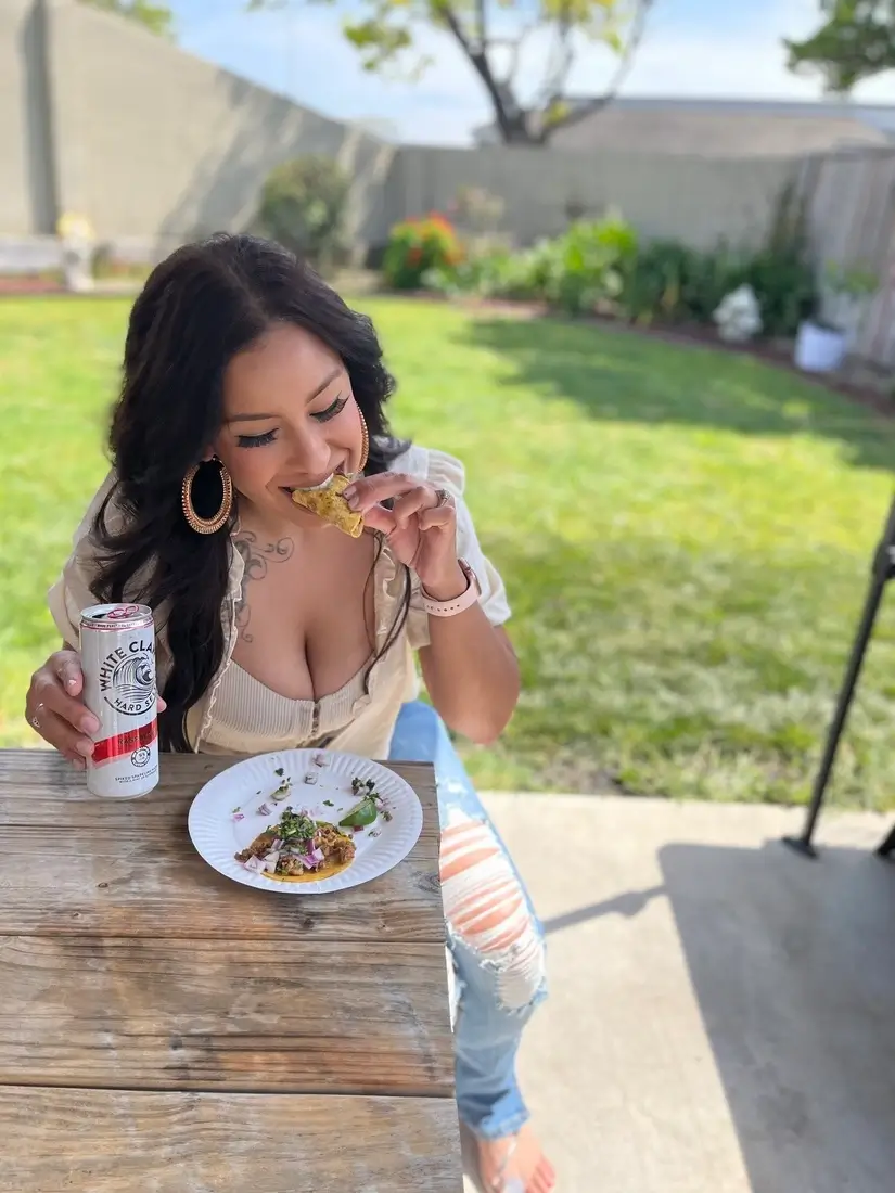 an image of a woman eating a taco